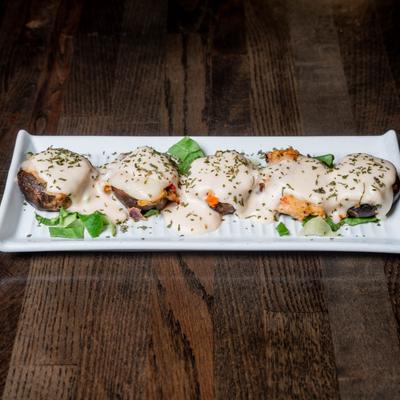 Crab-stuffed mushrooms topped with provolone cheese and Alfredo sauce.
