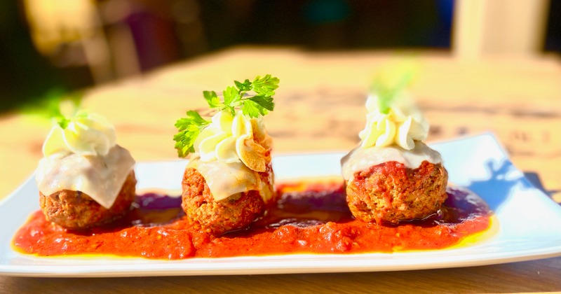 Meatballs in marinara sauce, with melted mozzarella and ricotta