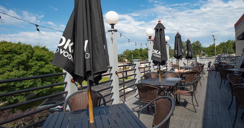 Patio, seating area with tables and chairs and patio umbrellas