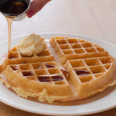 Plain waffle with maple syrup and butter.