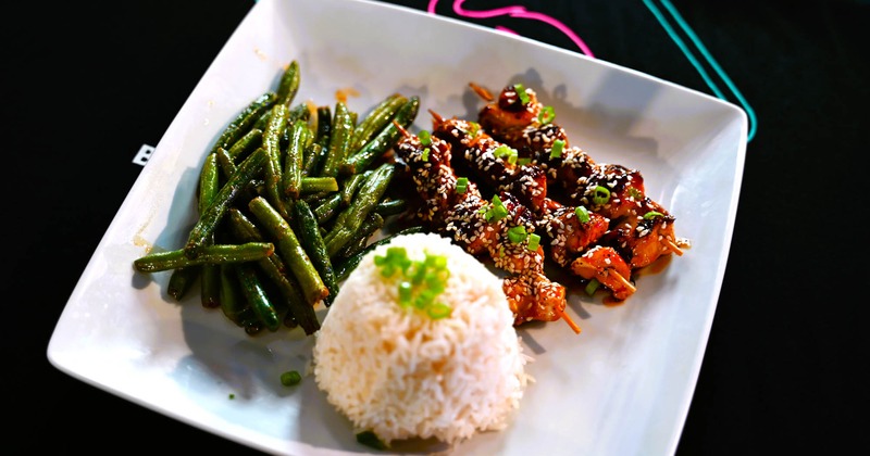 Chicken skewers, green beans, and rice