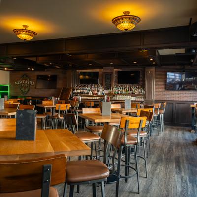 Interior with wooden tables, chairs and brick walls.