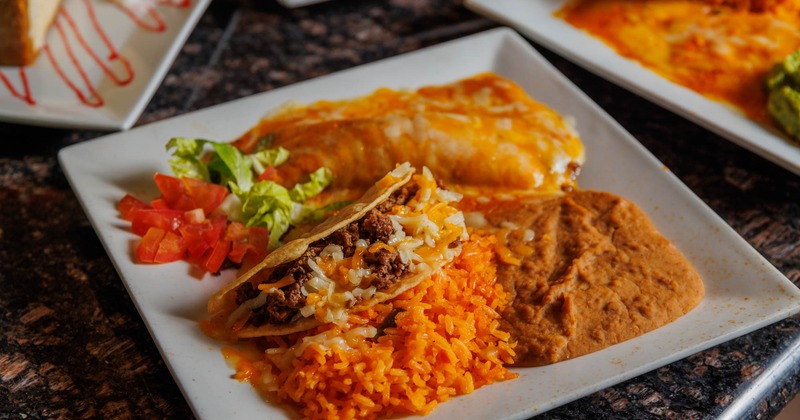 Tex Mex platter, with a taco, enchilada, rice, beans, and salad