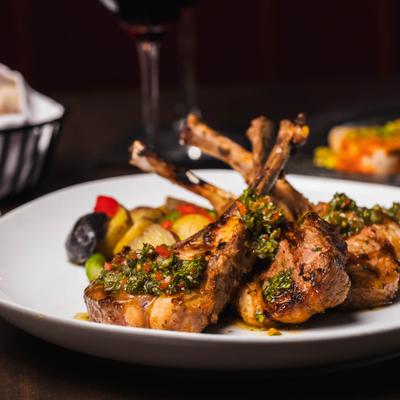 Char-grilled lamb chops served with mashed potatoes and vegetables.