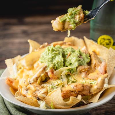 Bite of a meal on a fork above the Taco Salad.