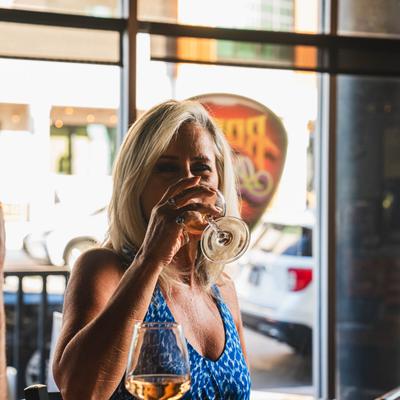 Interior, a guest drinking  wine.