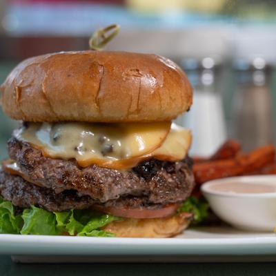 Double cheeseburger with lettuce and fries.