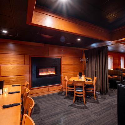 Interior, dining area, tables by the fireplace.
