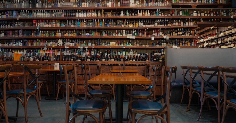 Table and chairs in front of the wine rack
