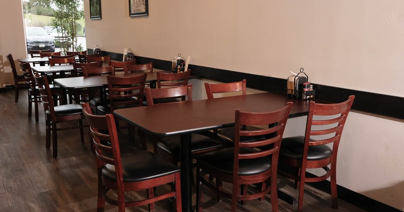 Interior, tables and chairs near wall