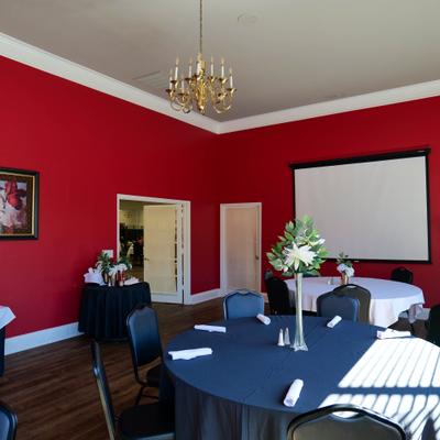 Room in a venue with a table set for dining.