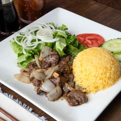 Shaken beef tossed with onions, served with rice and a salad.