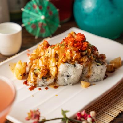 Volcano Roll topped with a creamy sauce and crunchy tempura flakes.