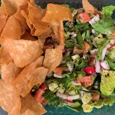 Fattoush salad featuring a mixture of fresh vegetables and crispy pita bread.