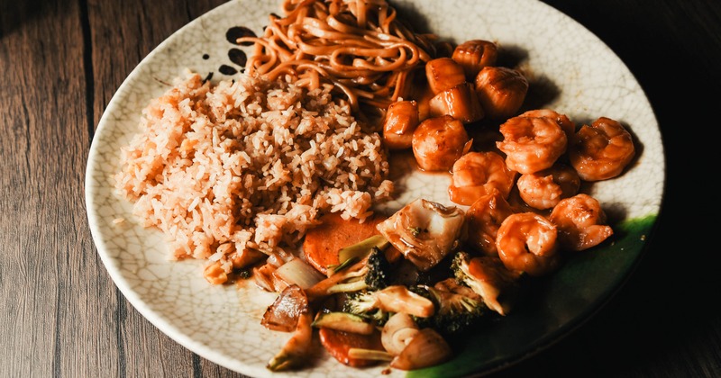 Shrimp and scallops hibachi meal with vegetables, rice, and noodles