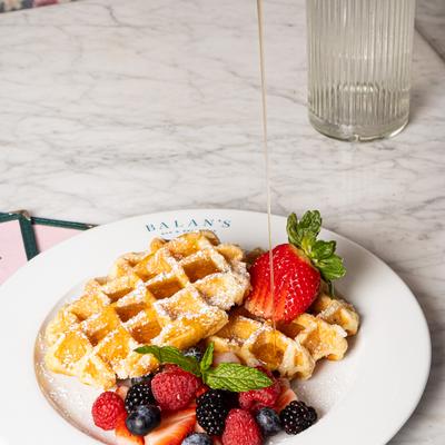 Belgian Waffles with fresh berries and maple syrup.