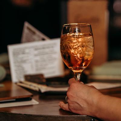 Drink in hand on a table, close up