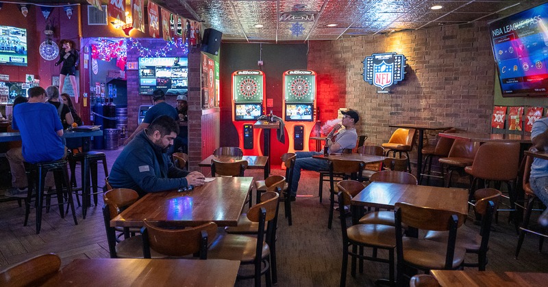 Interior, diner area, tables, chairs, screens, dart machines