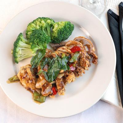 Spicy Basil Leaves With Chicken, served with broccoli.