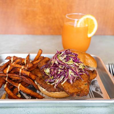 Fried fish sandwich, with cabbage slaw, and sweet potato fries.