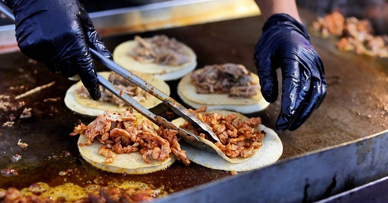Tacos being prepared on the grill