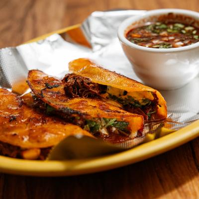 Birria tacos with beef broth.