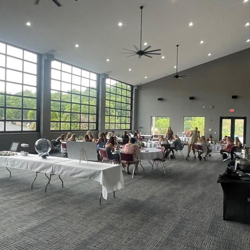 Guests sitting at tables in a large event hall.