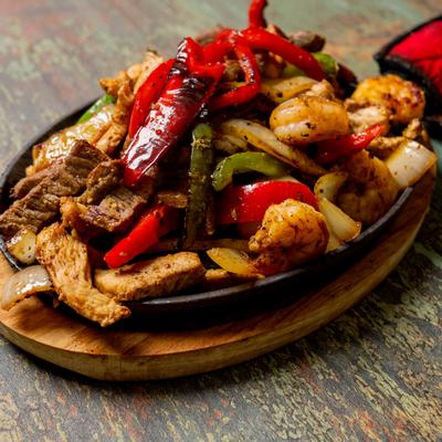Chicken fajitas served on the table.