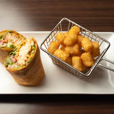 Chicken wrap with a side of tater tots.