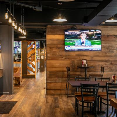 The interior space, tables, chairs, wall TV.