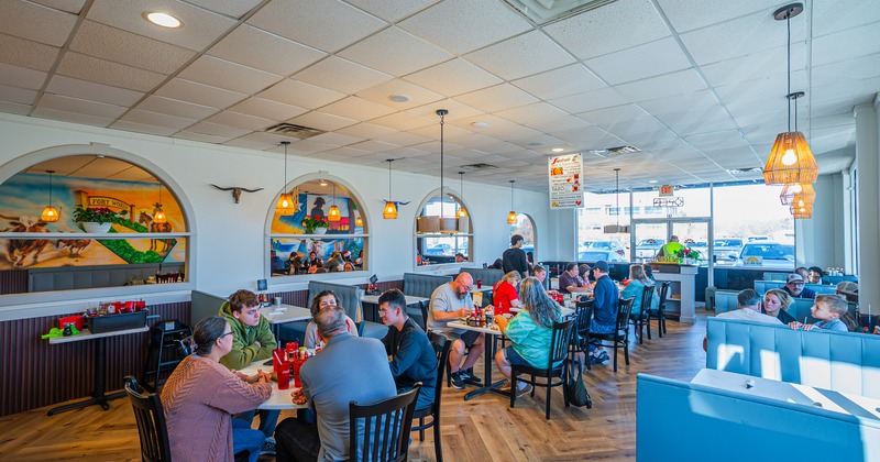 Interior dining area full of guests enjoying their food and drinks