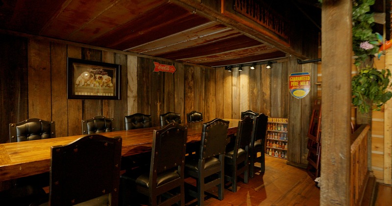 Private parties area perfect for small parties with a vast wooden table and upholstered chairs