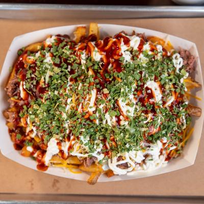 Loaded Fries, with pulled pork, cheese, sauce, sour cream, chives.