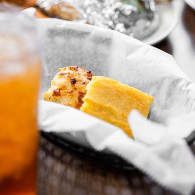 A close-up of cornbread pieces in a basket.