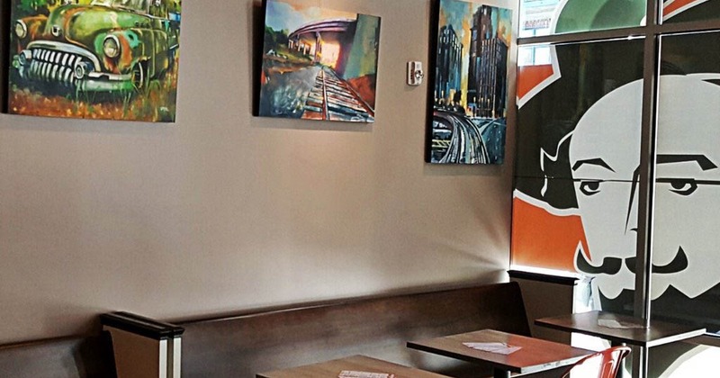 Interior, artwork on a wall, tables and seating
