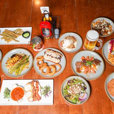 Large table of assorted meals and drinks.