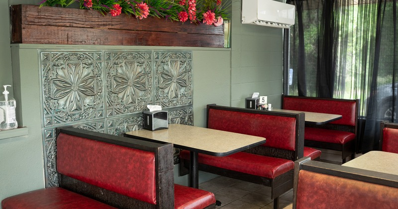 Interior dining area with upholstered red booths