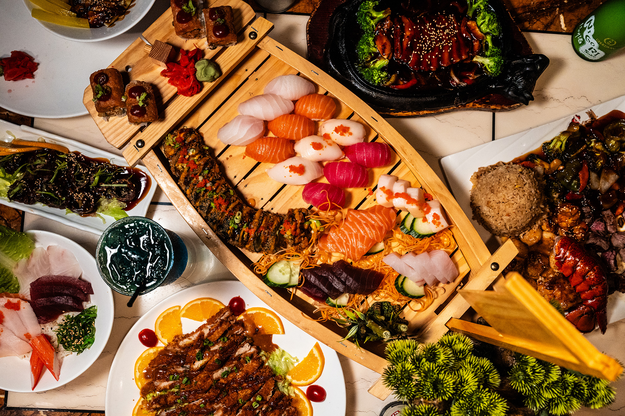 Assorted sushi and sashimi arranged on a wooden boat-style platter