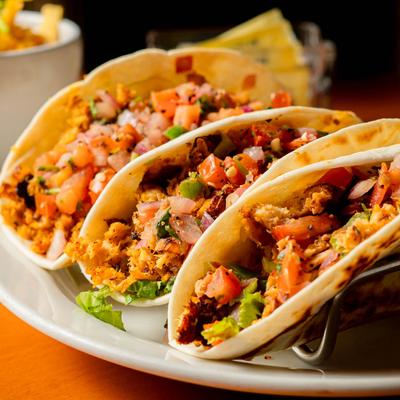 Fish Tacos, with lettuce, cheddar, jalapeno cheese, pico de gallo, and salsa.