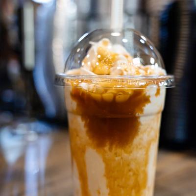 Caramel blended drink topped with whipped cream.