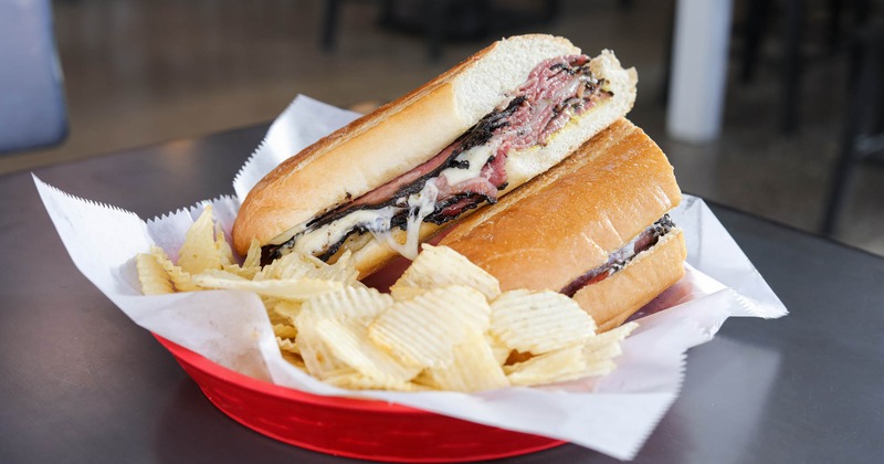 Pastrami sub sandwich, served with chips