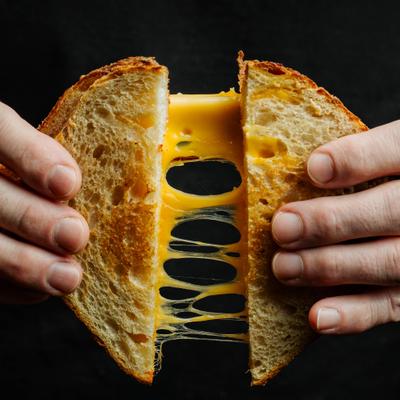Grilled cheese sandwich being pulled apart with a 