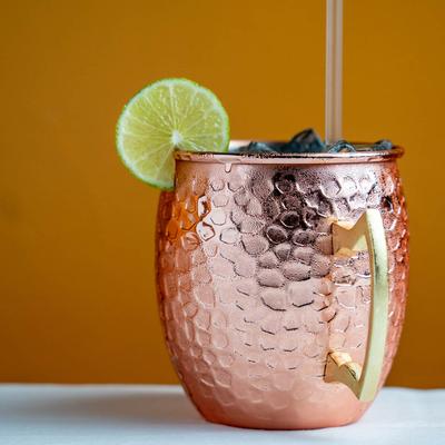 Sahib hangover cocktail served in a copper cup with a lime wheel garnish.