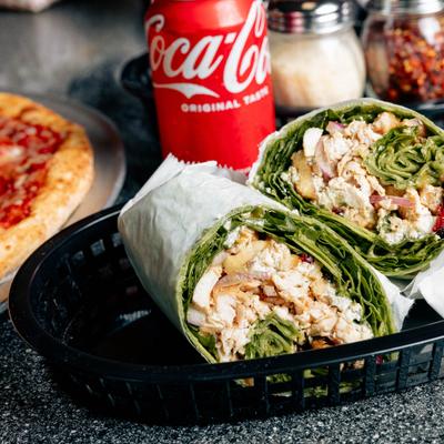 Chicken Caesar wrap served with a can of soda.