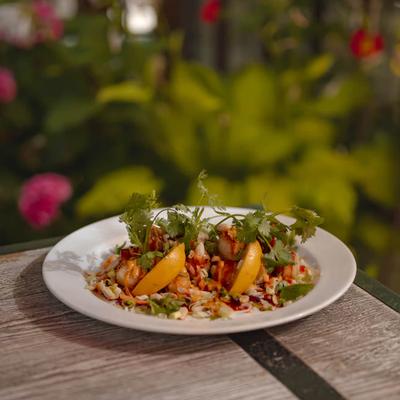 Seafood salad featuring shrimp,  fresh cilantro and slices of citrus fruit.