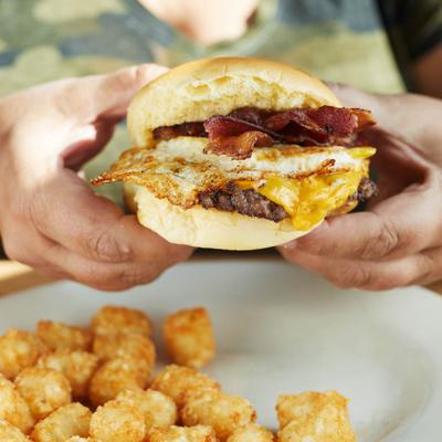 Bacon cheeseburger, with a fried egg, and a side of tater tots.