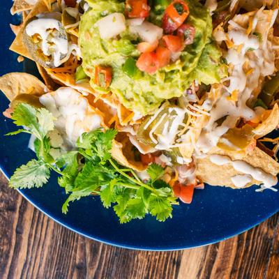 Vaquero Tex Mex nachos with lettuce and tomatoes.