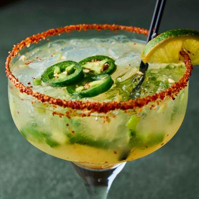 A spicy jalapeno margarita served in a traditional margarita glass.