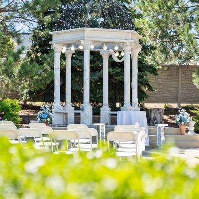 Arranged white chairs and a white gazebo outside