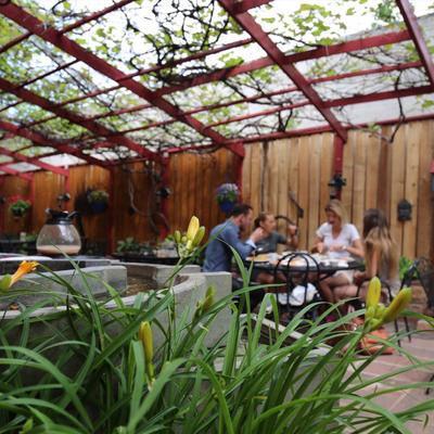 Patio,seating area decorated with plants and a stone fountain with Buddha sculptures